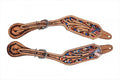 Floral tooled spur straps with red white and blue gems.